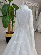 Luxury hijab wedding dress with long sleeves, high mock neck, floral lace embroidery, detachable mermaid skirt, dramatic train and premium lace veil for a modest Muslim bride.