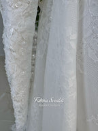 Luxury hijab wedding dress with long sleeves, high mock neck, floral lace embroidery, detachable mermaid skirt, dramatic train and premium lace veil for a modest Muslim bride.