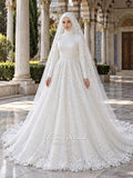 White A-line hijab wedding dress with a high-neck satin bodice, long sleeves, and a beaded botanical lace tulle skirt with a sweeping train. Displayed beside a coordinating lace-trimmed veil.