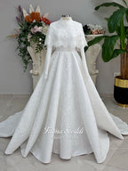 Elegant hijab wedding dress with long sleeves, high neck, detachable lace cape, cathedral train, and premium lace veil included. Luxury modest bridal couture gown in white with floral lace detailing.
