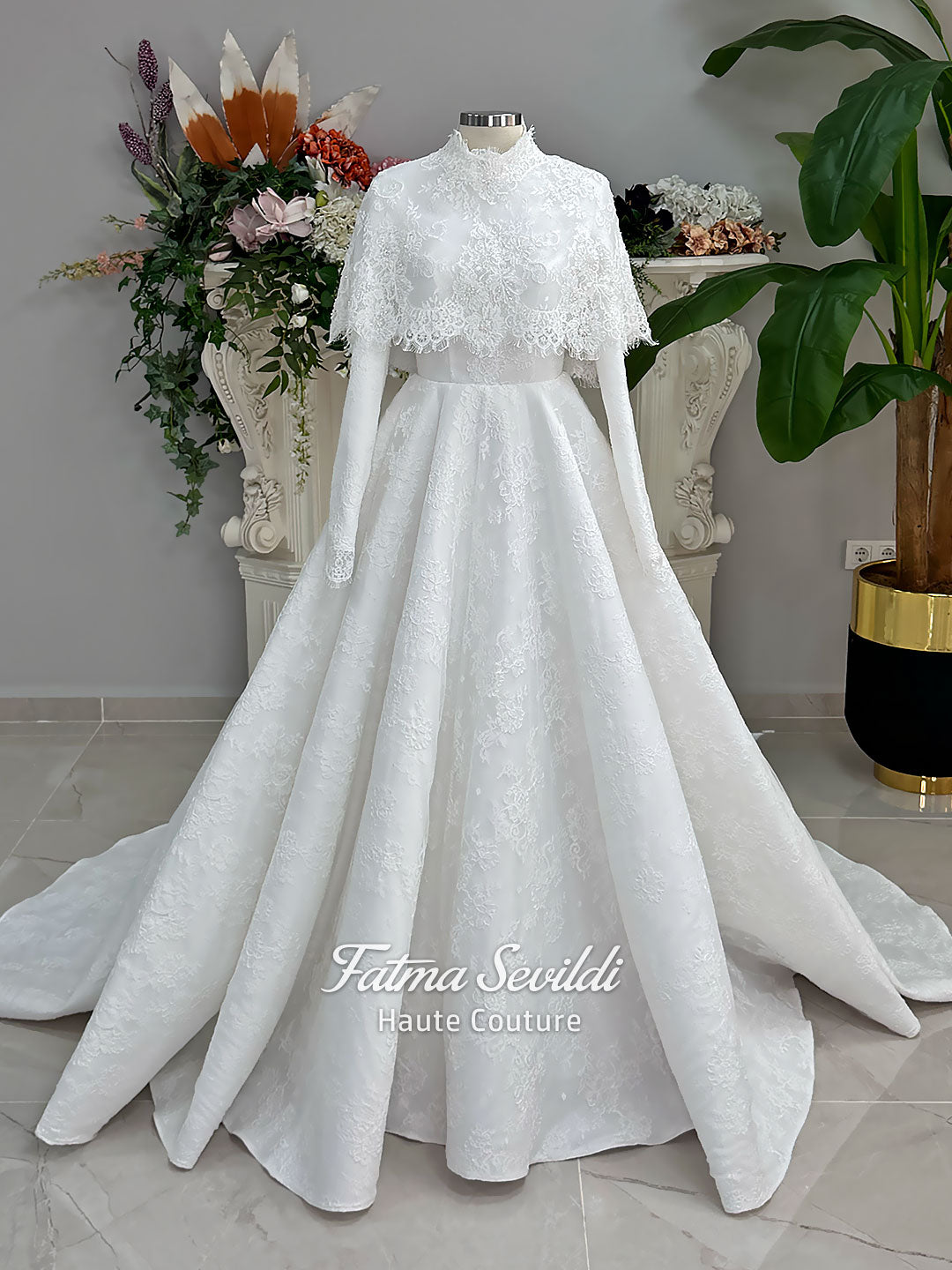 Elegant hijab wedding dress with long sleeves, high neck, detachable lace cape, cathedral train, and premium lace veil included. Luxury modest bridal couture gown in white with floral lace detailing.