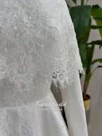 Elegant hijab wedding dress with long sleeves, high neck, detachable lace cape, cathedral train, and premium lace veil included. Luxury modest bridal couture gown in white with floral lace detailing.