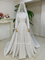 Shimmering white hijab wedding dress with beaded lace veil, high neck