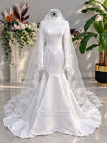 White mermaid satin-look hijab wedding dress with a high neckline, long sleeves, fitted bodice and floor-length train, styled with an intricate floral lace bridal veil. Fatma Sevildi Haute Couture modest bridal design.