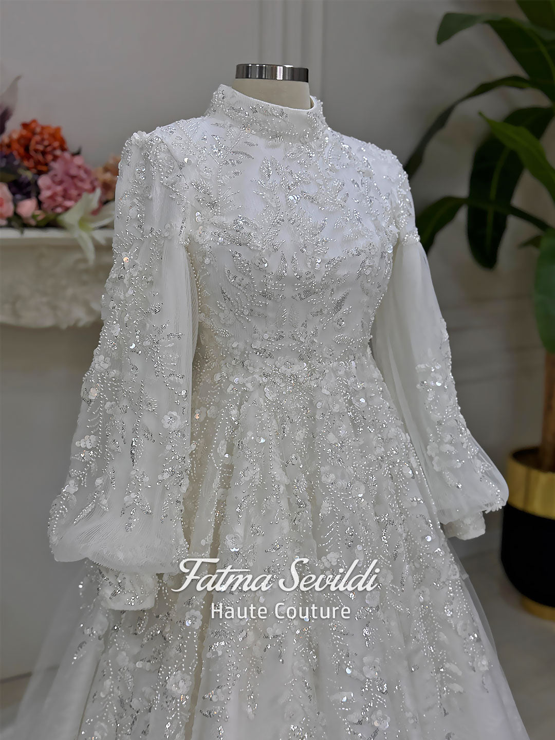 Luxury Muslim wedding dress with high neck, long sleeves, beaded lace embroidery, full A-line skirt, and matching premium lace veil. Elegant modest bridal gown custom made for hijab brides seeking a couture wedding look.