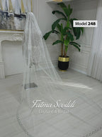 Delicate lace edge cathedral bridal veil with hand-sewn silver beading