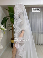 White sheer cathedral veil with lace edging on mannequin