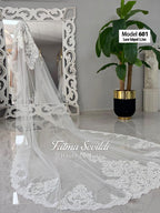 Delicate white lace-edged cathedral bridal veil with floral embroidery
