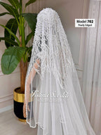 Delicate pearl-edged white bridal veil by Fatma Sevildi, hand-sewn beaded lace