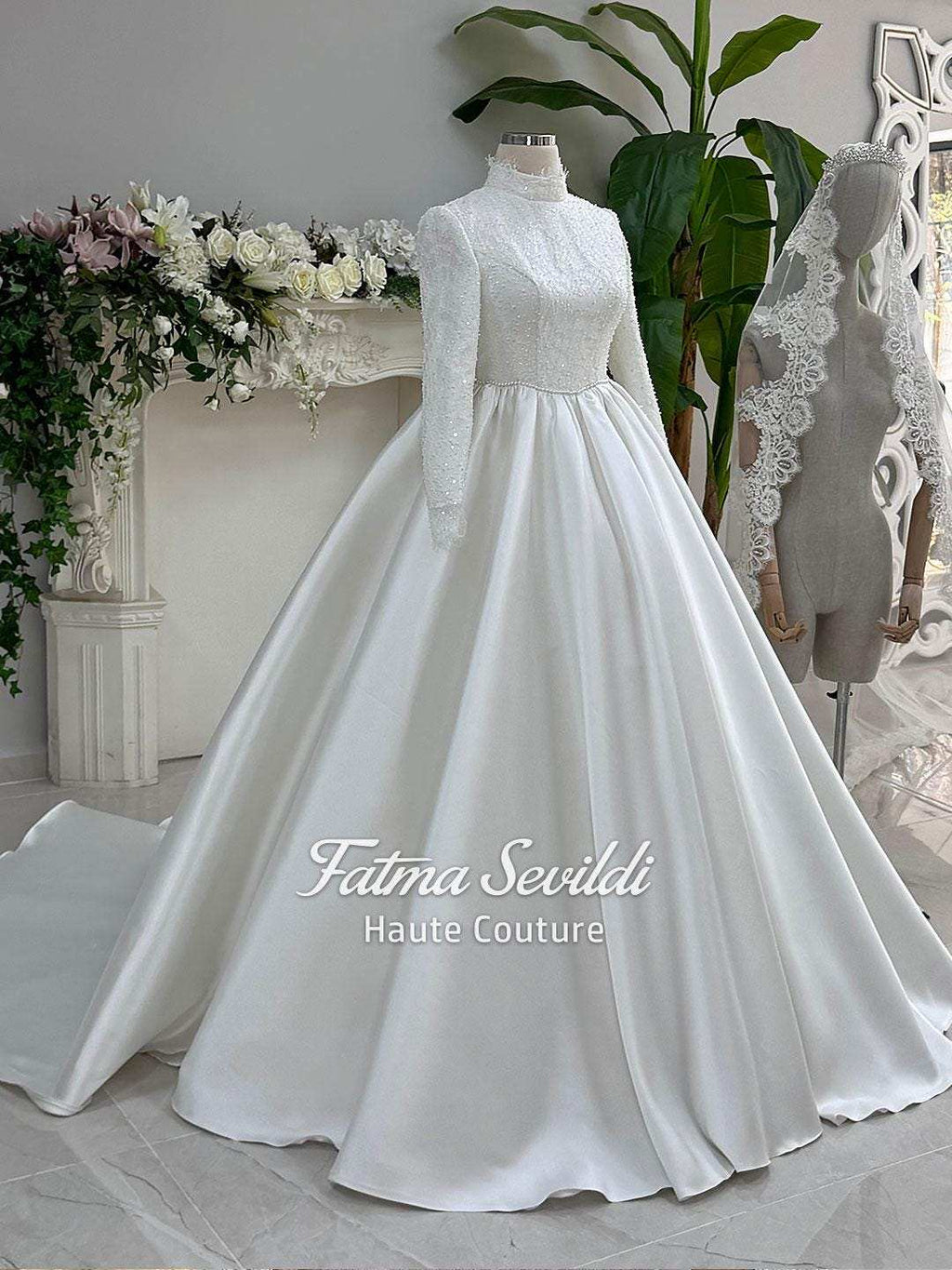 Elegant veiled hijab wedding gown in white beaded lace satin with high neck and long sleeves