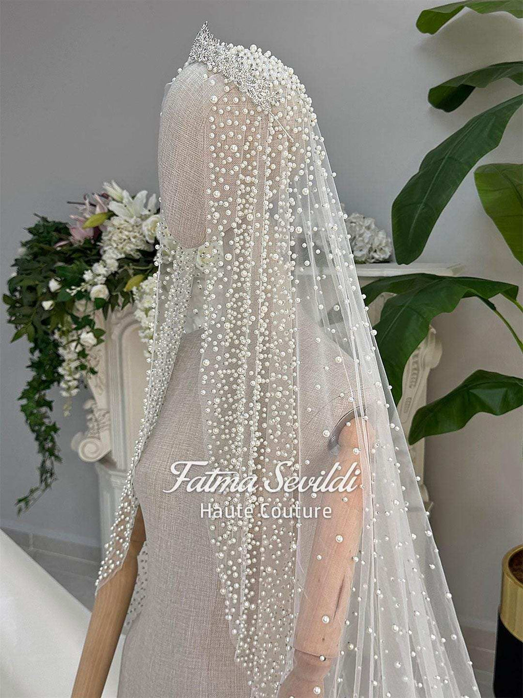 Delicate white beaded veil with sparkling tiara on veiled hijab wedding gown