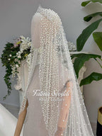 Delicate white beaded veil with sparkling tiara on veiled hijab wedding gown