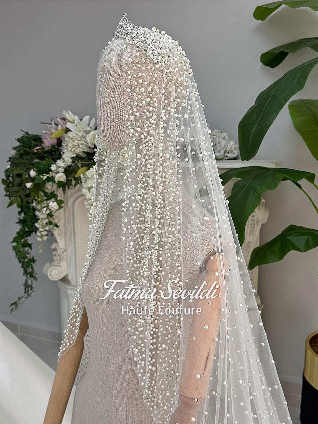 Delicate white beaded veil with sparkling tiara on veiled hijab wedding gown