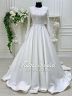 Elegant white satin A-line wedding gown with lace sleeves and veil