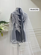 Delicate sheer white veil with silver beaded feathers on satin modest wedding dress