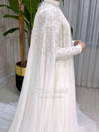 Elegant white satin Muslim wedding dress by Fatma Sevildi with silver beading