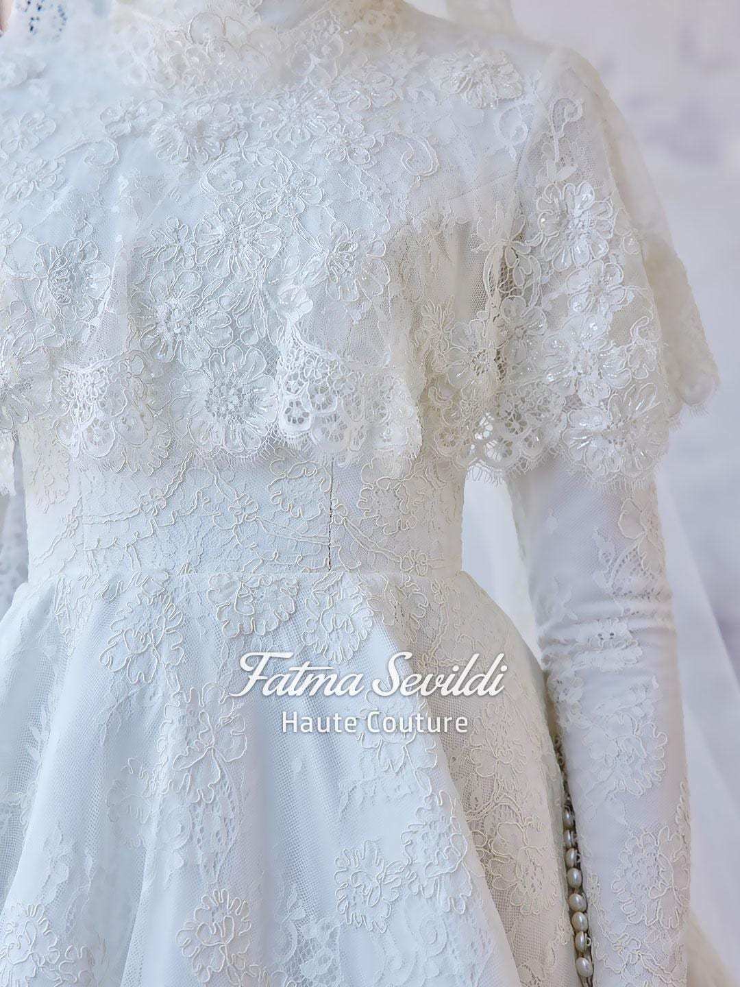 Delicate white lace hijab wedding gown with floral embroidery by Fatma Sevildi