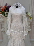 White beaded mermaid wedding gown with long sleeves, lace veil by Fatma Sevildi