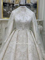 Luxurious ivory veiled modest wedding gown with beaded lace, high neck, long sleeves