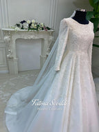 Luxury veiled hijab wedding dress with beaded lace, long sleeves, full coverage bodice, and elegant A-line bridal silhouette. Modest Muslim wedding gown with custom couture detailing and romantic lace veil.