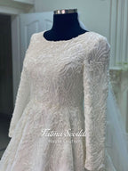 Luxury veiled hijab wedding dress with beaded lace, long sleeves, full coverage bodice, and elegant A-line bridal silhouette. Modest Muslim wedding gown with custom couture detailing and romantic lace veil.