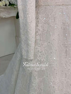Delicate ivory veiled hijab wedding dress with beaded lace, long sleeves, high neck, floral patterns and sparkling sequins