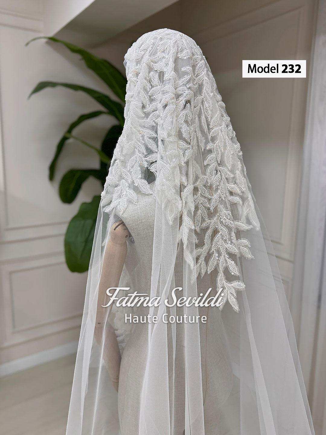 Elegant white lace veiled hijab wedding dress by Fatma Sevildi