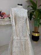 Elegant ivory Fatma Sevildi veiled hijab wedding gown with silver beading