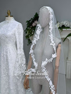 Veiled hijab wedding dress with high neck, long sleeves, and beaded floral lace in an elegant A-line couture silhouette.