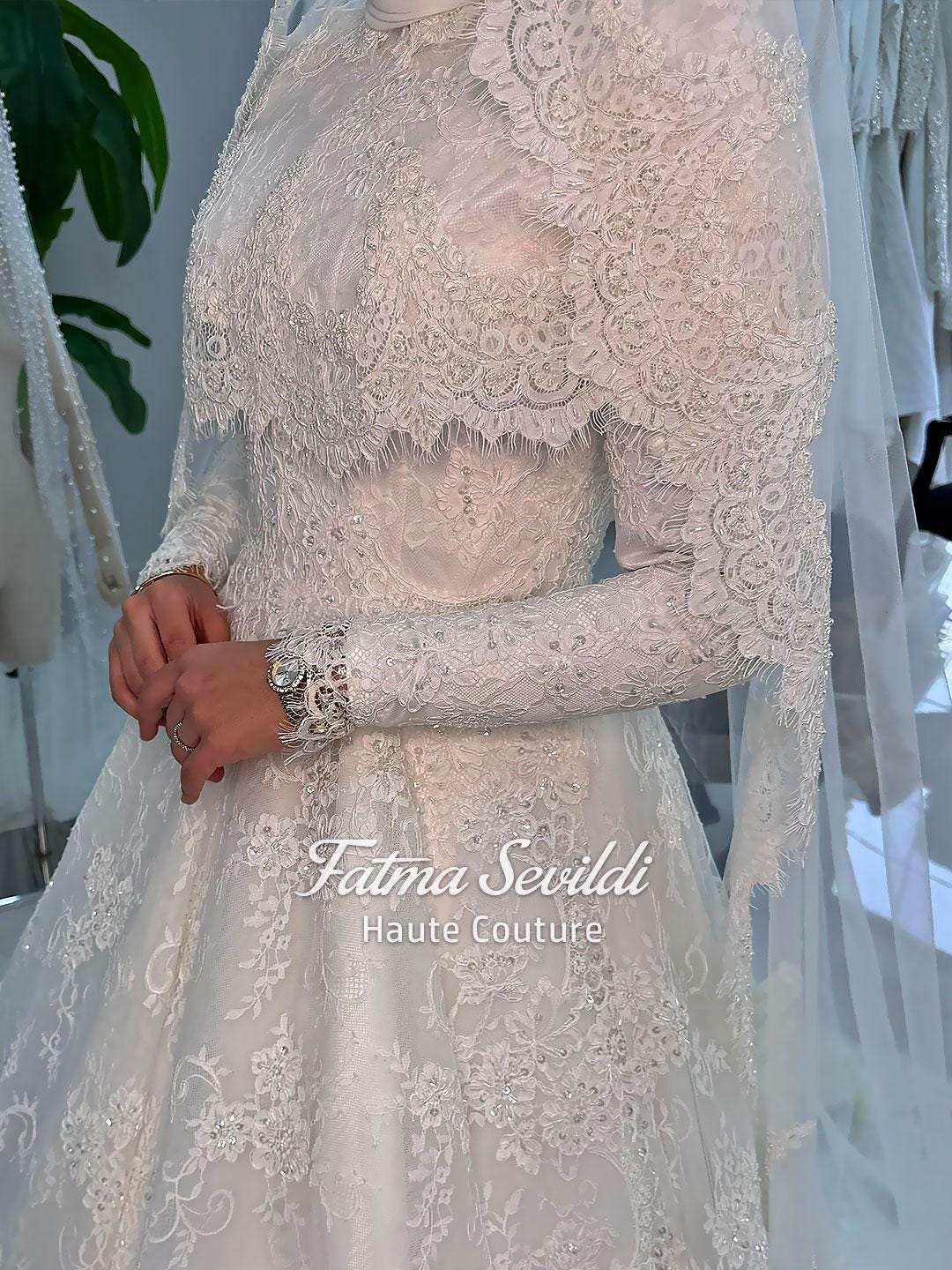 Delicate ivory lace wedding gown with veiled hijab capelet, long sleeves, high neck