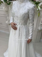 Veiled Muslim wedding dress by Fatma Sevildi with beaded lace sleeves