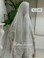 Delicate white beaded veil with floral embroidery on mannequin, for modest Muslim bridal gown