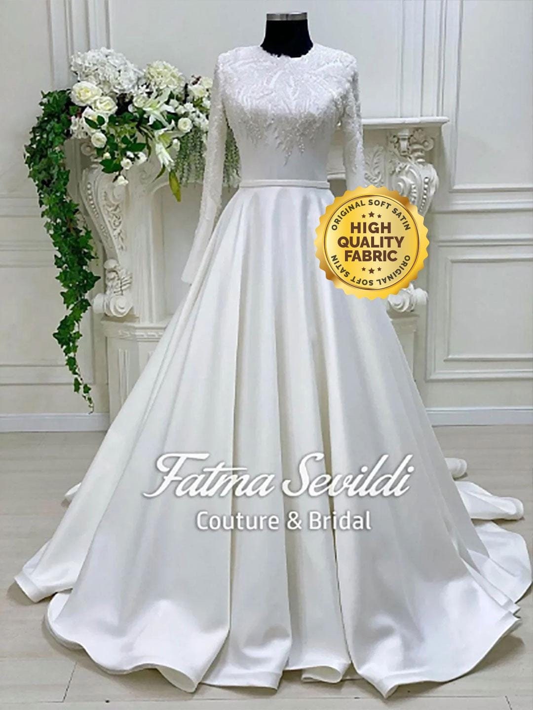 White satin modest A-line wedding dress with lace bodice, long sleeves and veil
