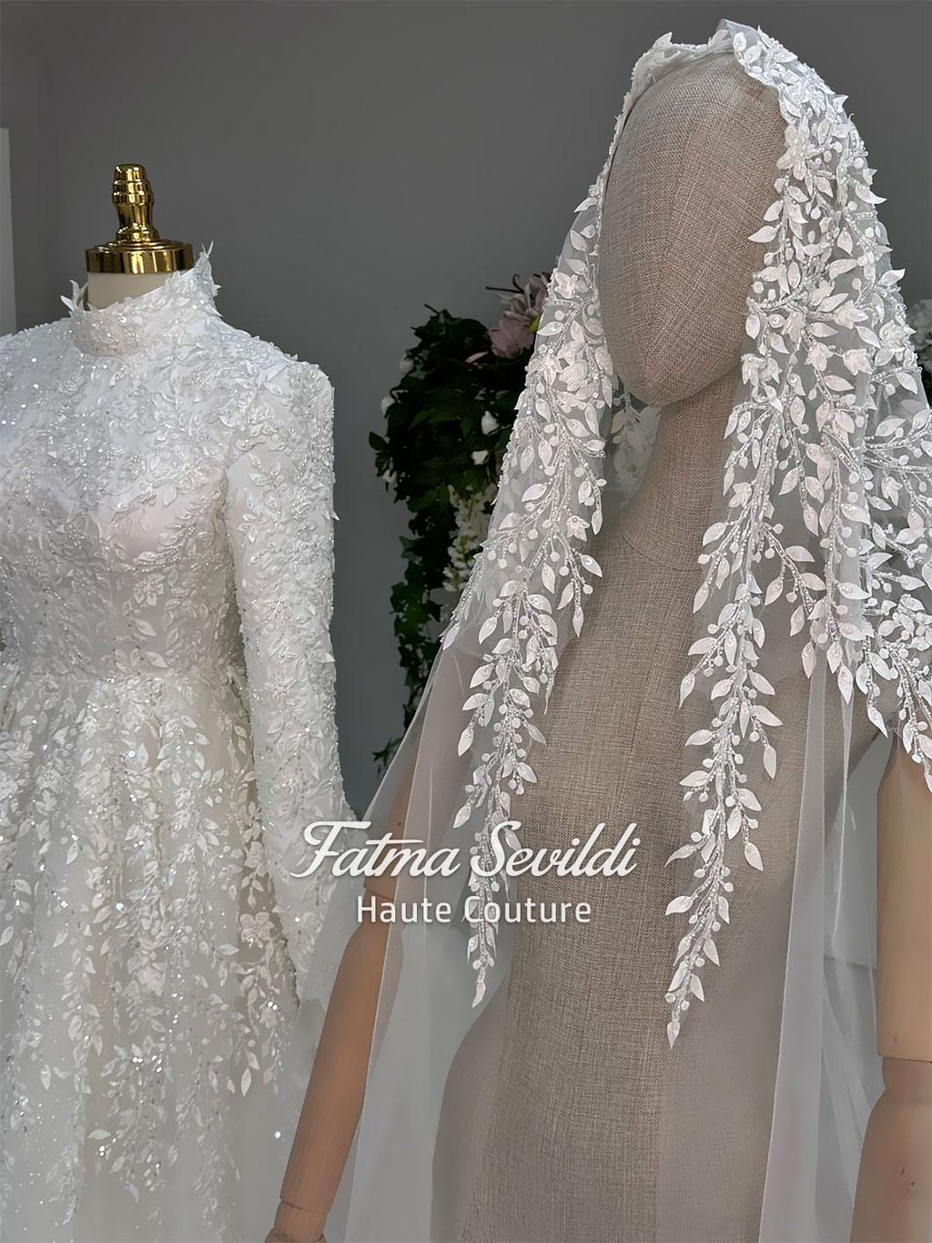 Delicate white lace veil with leaf berry embroidery beside modest hijab wedding gown