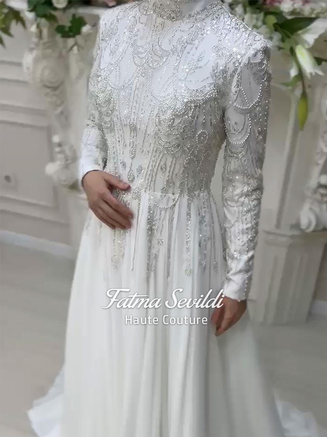 Veiled Muslim wedding dress by Fatma Sevildi with beaded lace sleeves