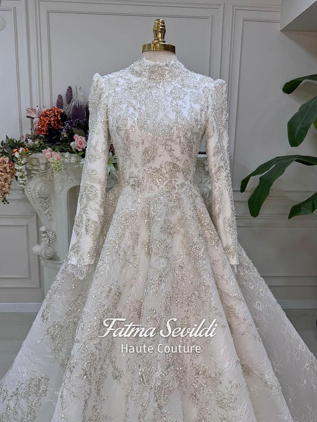 Luxurious ivory veiled modest wedding gown with beaded lace skirt