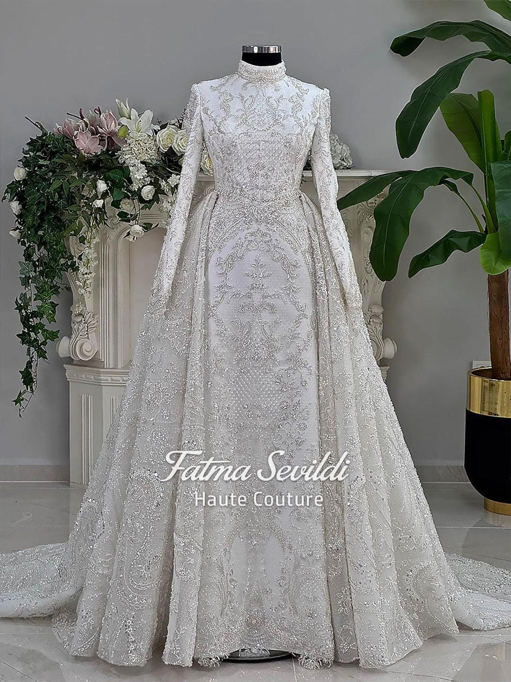 Luxury modest hijab wedding dress with white lace, silver embroidery, long sleeves, veil, and beading on mannequin