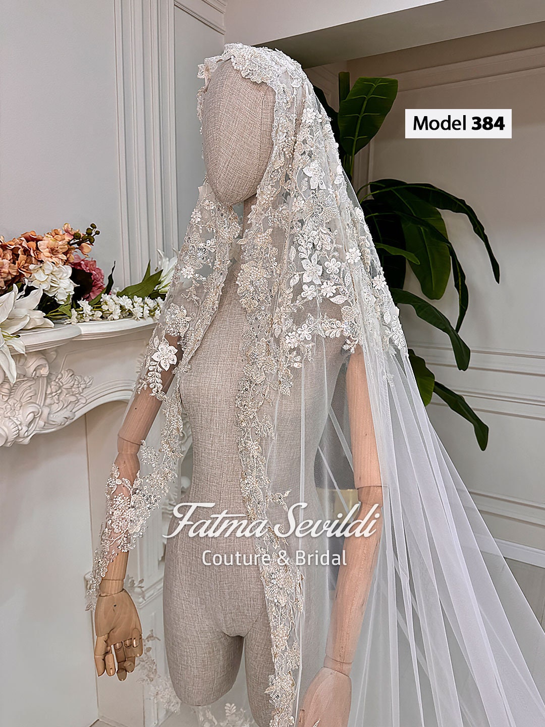 Delicate white lace bridal veil with 3D floral embroidery on mannequin