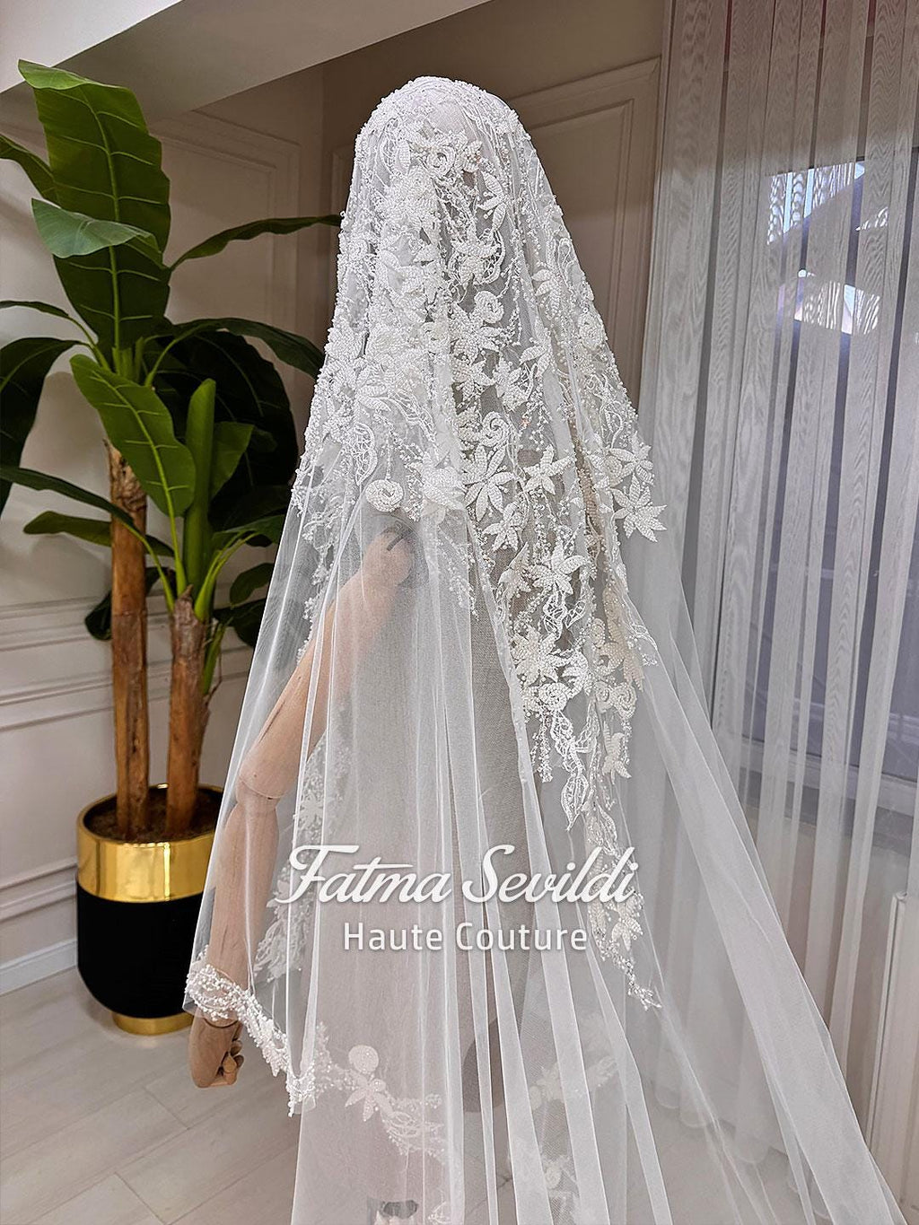 Delicate white lace bridal veil with floral embroidery by Fatma Sevildi
