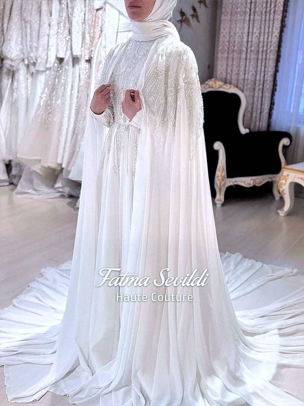 Satin Muslim wedding dress with long silver-beaded cape and sleeves