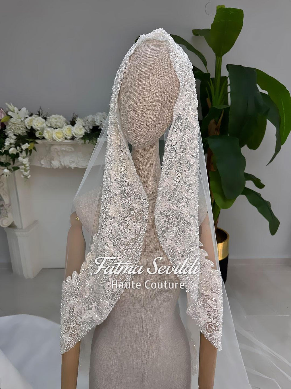 Delicate ivory lace bridal veil with floral patterns and beading