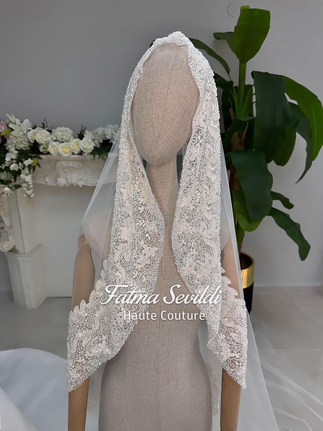 Delicate ivory lace bridal veil with floral patterns and beading