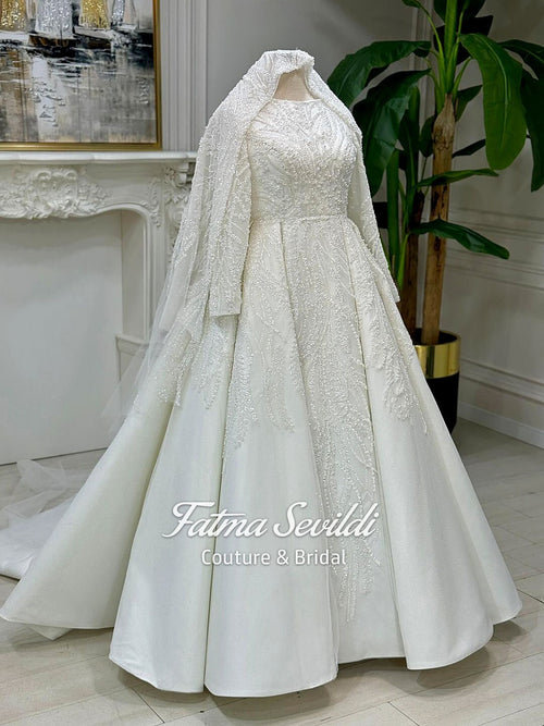 Beaded lace Muslim wedding dress with embroidered veil on mannequin