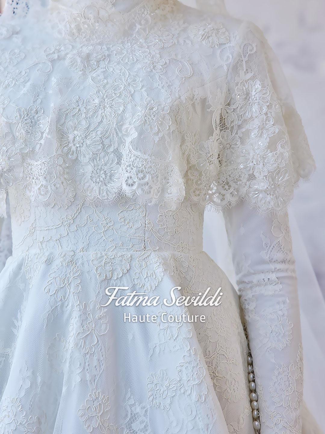 Delicate white lace hijab wedding gown with floral embroidery by Fatma Sevildi