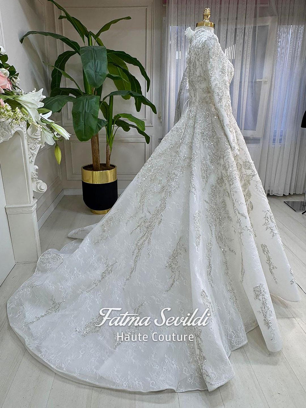 Veiled modest wedding dress with silver embroidery and long train