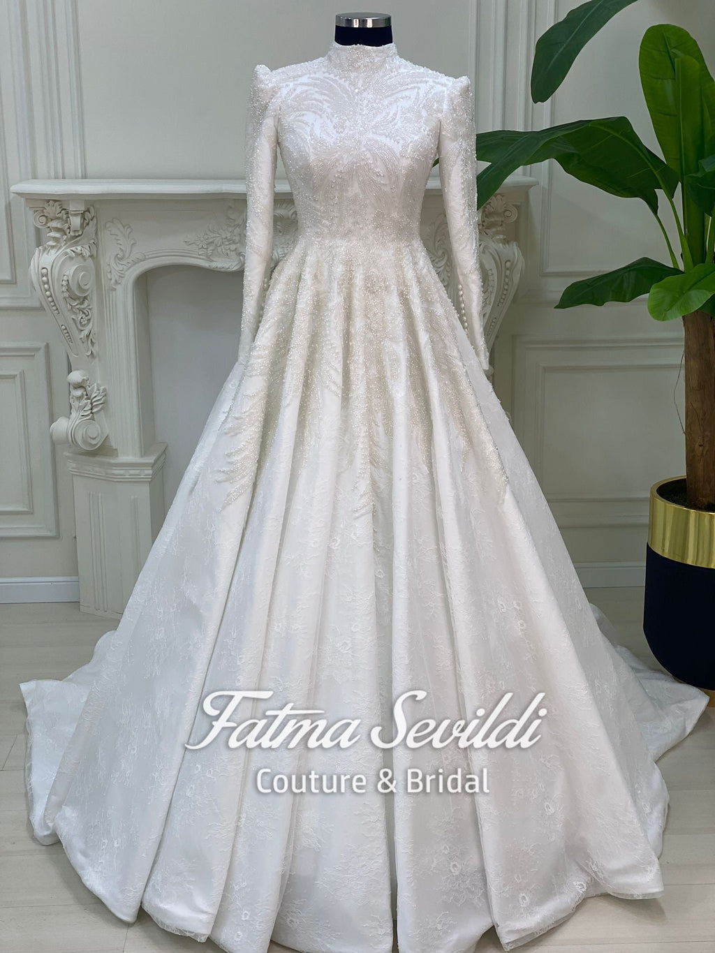 Elegant beaded lace Muslim wedding dress with high neck, long sleeves, and veil
