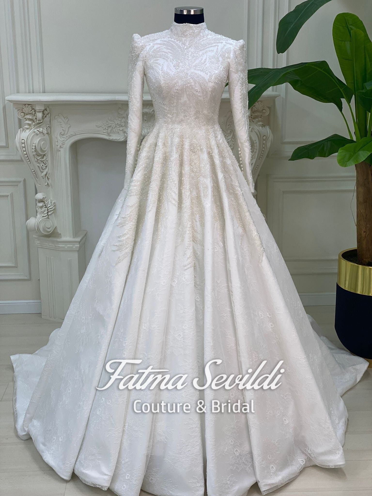Elegant beaded lace Muslim wedding dress with high neck, long sleeves, and veil