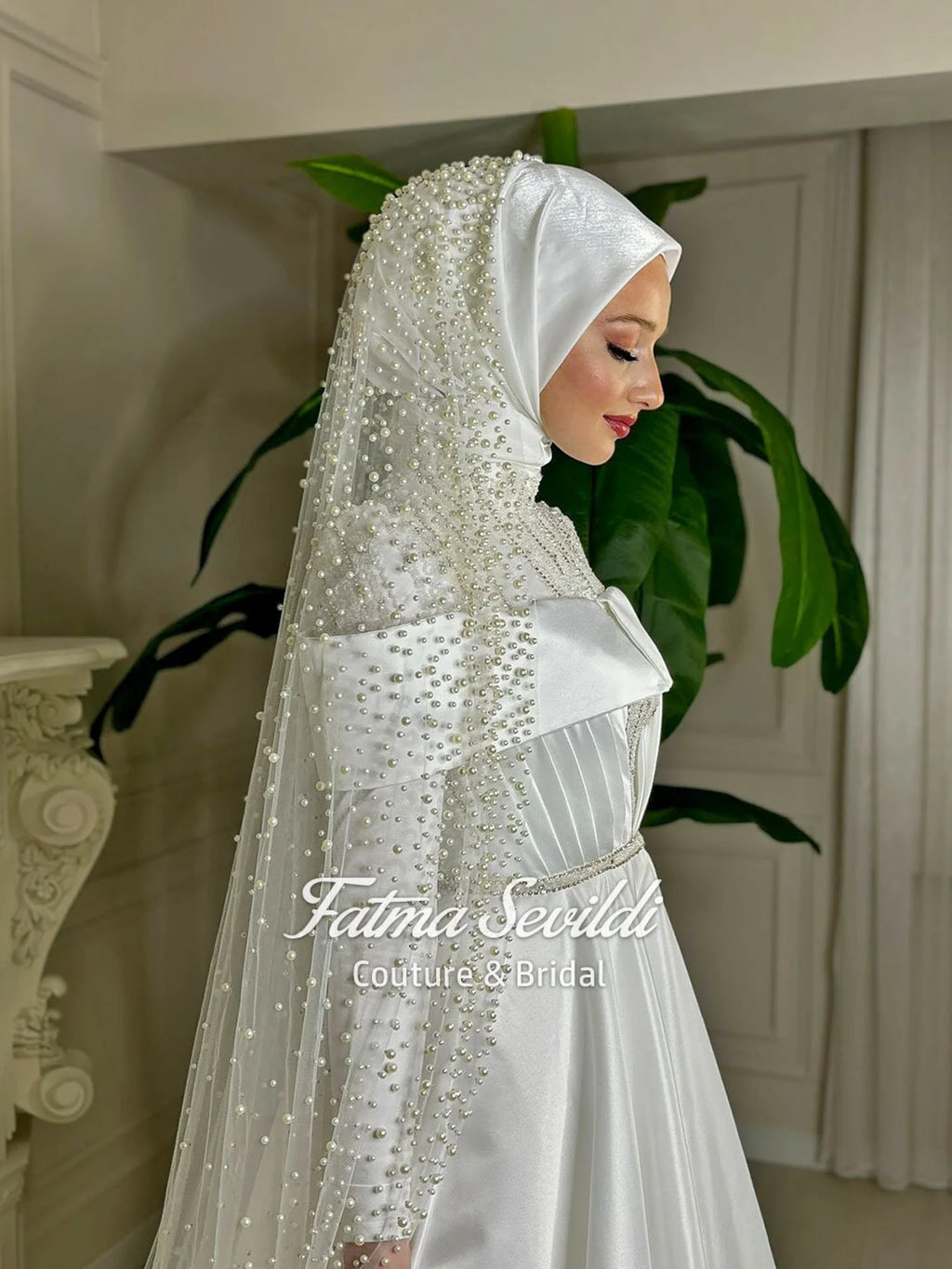 Elegant white satin bridal hijab with beading, lace, and pearl veil