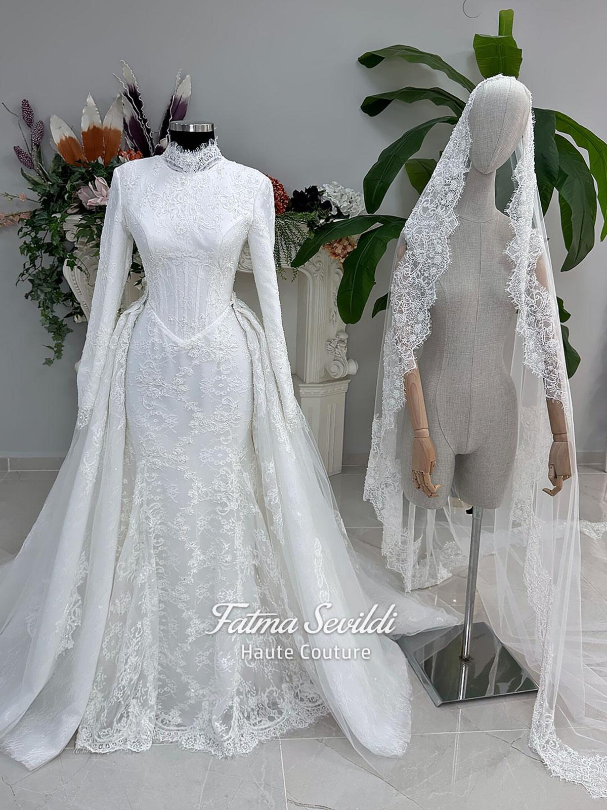 White hijab wedding dress with long sleeves, floral lace, high neckline and detachable overskirt, styled with a premium lace veil. Luxury modest bridal gown designed for a fully covered Muslim bridal look.