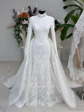 White hijab wedding dress with long sleeves, floral lace, high neckline and detachable overskirt, styled with a premium lace veil. Luxury modest bridal gown designed for a fully covered Muslim bridal look.
